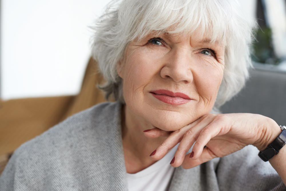close up portrait beautiful positive middle aged caucasian lady retirement daydreaming home thinking about her grandchildren elegant gray haired grandmother spending time in
